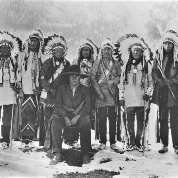 Jack Wilson with Arapaho from Fort Washakie, WY who appeared in the movie "The Covered Wagon,"  1923. Among those pictured: Charlie Whiteman; Rising Buffalo; Red Pipe; Woman Dress; Chief Lodge; Night Horse; Painted Wolf; Many Tipi Poles